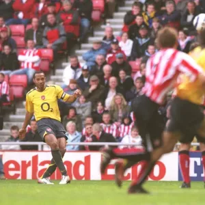 Theirry Henry shoots past Sunderland goalkeeper Kelvin Davis to score the 3rd Arsenal goal from a fr