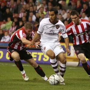 Theo Walcott (Arsenal) Chris Armstrong and Chris Morgan (Sheff) Theo Walcott (Arsenal) Chris Armstrong and Chris Morgan (Sheff)