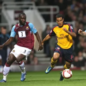 Theo Walcott (Arsenal) Herita Ilunga and James Collins (West Ham) Theo Walcott (Arsenal) Herita Ilunga and James Collins (West Ham)