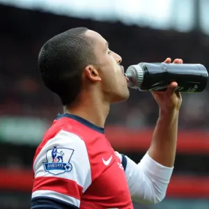 Theo Walcott (Arsenal) with a Lucazade bottle. Arsenal 3: 3 Fulham. Barclays Premier League