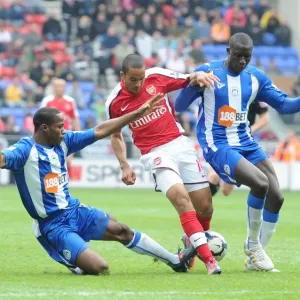 Theo Walcott (Arsenal) Maynor Figueroa and Mohamed Diame (Wigan). Wigan Athletic 3