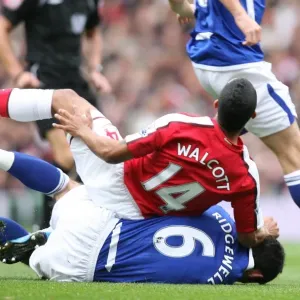 Theo Walcott (Arsenal) is tackled by Liam Ridgewell (Birmingham) Theo Walcott (Arsenal) is tackled by Liam Ridgewell (Birmingham)