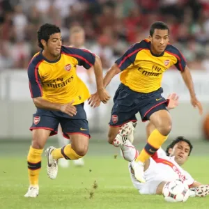Theo Walcott and Carlos Vela (Arsenal) Tasci (Stuttgart) Theo Walcott and Carlos Vela (Arsenal) Tasci (Stuttgart)