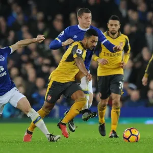 Theo Walcott Clashes with Everton's Leighton Baines and Ross Barkley during the Intense Everton vs Arsenal Premier League Match, 2016-17