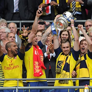 Theo Walcott, Olivier Giroud, Aaron Ramsey and Nacho Monreal (Arsenal) lift the FA