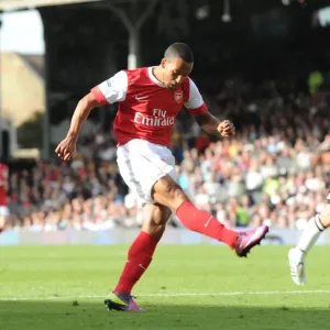 Theo Walcott shoots past Fulham goalkeeper Mark Schwarzer to score the 2nd Arsenal goal