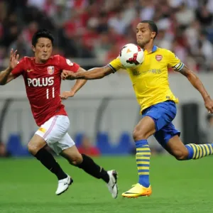 Theo Walcott vs. Kunimitsu Sekiguchi: A Battle for Ball Possession in Arsenal's 2013 Pre-Season Clash with Urawa Red Diamonds Theo Walcott vs. Kunimitsu Sekiguchi: A Battle for Ball Possession in Arsenal's 2013 Pre-Season Clash with Urawa Red Diamonds