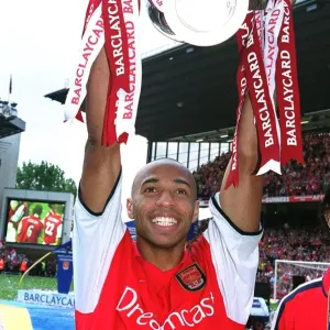 Thierry Henry (Arsenal) lifts the F. A. Barclaycard Premiership Trophy