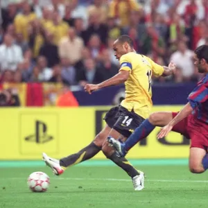 Thierry Henry (Arsenal) shoots under pressure from Rafael Marquez (Barcelona) Thierry Henry (Arsenal) shoots under pressure from Rafael Marquez (Barcelona)