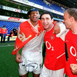 Thierry Henry, Martin Keown and Dennis Bergkamp (Arsenal) celebrate winning the league