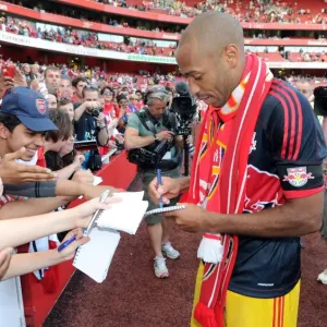 Thierry Henry (Red Bulls) signs autographs for the fans at the end of the match
