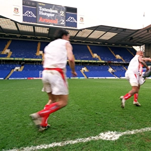 Thierry Henry runs off with the inflatable trophy followed by Robert Pires
