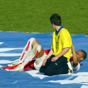 Thierry henry signs a shirt for a fan at the end of the match as Sol Campbell Thierry henry signs a shirt for a fan at the end of the match as Sol Campbell