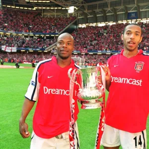 Thierry Henry and Sylvain Wiltord celebrate the Arsenal victory