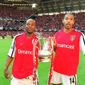 Thierry Henry and Sylvain Wiltord celebrate the Arsenal victory