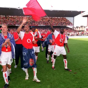 Thierry Henry waves to the fans as the players do a lap of honour