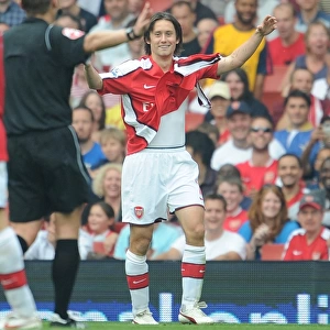 Tomas Rosicky (Arsenal) shows the referee his torn shirt