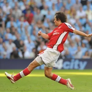 Tomas Rosicky shoots past Man City goalkeeper Shay