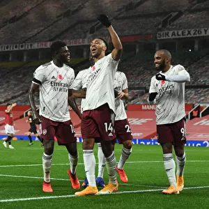 Triumphant Threesome: Aubameyang, Partey, and Lacazette's Goal Celebration - Arsenal's Victory at Old Trafford (2020-21)