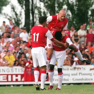 Triumphant Threesome: Kolo Toure, Pascal Cygan, and Robin van Persie Celebrate Arsenal's Pre-Season Goal