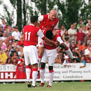 Triumphant Threesome: Kolo Toure, Pascal Cygan, and Robin van Persie Celebrate Arsenal's Pre-Season Goal