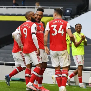 Triumphant Threesome: Lacazette, Aubameyang, and Xhaka's Victory Celebration (Arsenal vs. Tottenham, 2019-2020)