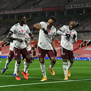 Triumphant Trio: Aubameyang, Partey, and Lacazette Celebrate Goal at Empty Old Trafford (Manchester United vs Arsenal, 2020-21)