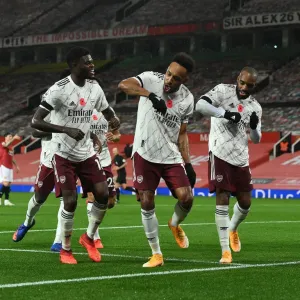 Triumphant Trio: Aubameyang, Partey, and Lacazette Celebrate Goal at Empty Old Trafford (Manchester United vs Arsenal, 2020-21) Triumphant Trio: Aubameyang, Partey, and Lacazette Celebrate Goal at Empty Old Trafford (Manchester United vs Arsenal, 2020-21)