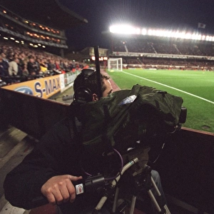 A TV Cameraman works under the floodlights which are on for the last time