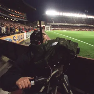 A TV Cameraman works under the floodlights which are on for the last time