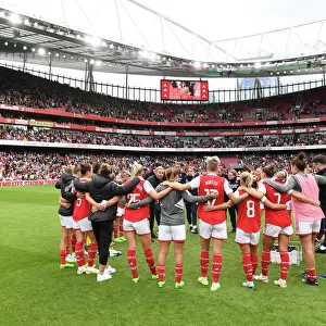 United in Determination: Arsenal and Tottenham Women Post-Match Huddle at Emirates Stadium