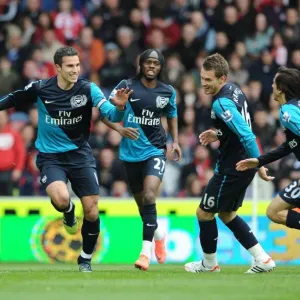United in Victory: Van Persie, Gervinho, Ramsey, and Benayoun Celebrate Goal Against Stoke City