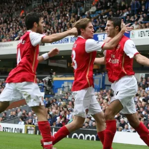 Van Persie's Euphoric Moment: Celebrating with Hleb and Fabregas against Blackburn Rovers