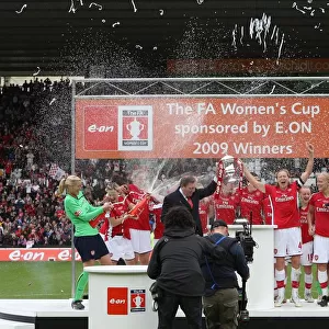 Vic Akers and his Arsenal Ladies lift the FA Cup Trophy
