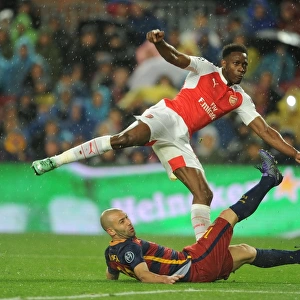 Welbeck vs Mascherano: A Tense Moment in Arsenal's Battle at Camp Nou against Barcelona