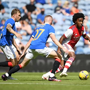 Willian Clashes with Rangers Scott Arfield and Stephen Kelly in Arsenal's Pre-Season Friendly at Ibrox Stadium