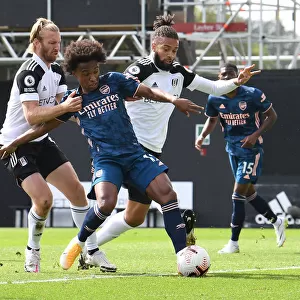 Willian Faces Off Against Fulham Defenders Ream and Hector in Arsenal's Premier League Clash