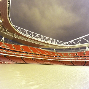 Winter's Grip: Arsenal's Emirates Stadium Blanketed in Snow during Premier League Match