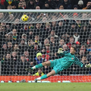 Wojciech Szczesny (Arsenal) looks on as Wayne Rooneys penalty saile over the crossbar