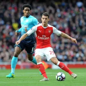 Xhaka Under Pressure: Arsenal's Midfielder Faces Intense Scrutiny from Swansea's Fer in Premier League Showdown