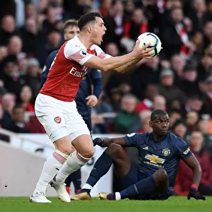 Xhaka vs Pogba: Intense Clash Between Arsenal's Granit Xhaka and Manchester United's Paul Pogba during the Premier League Match