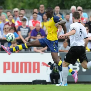 Yaya Sanogo (Arsenal) Callum Reynolds (Boreham Wood). Boreham Wood 0: 2 Arsenal. Pre Season Friendly