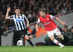 Images Dated 28th April 2014: Aaron Ramsey (Arsenal) Mathieu Debuchy (Newcastle). Arsenal 2: 0 Newcastle United