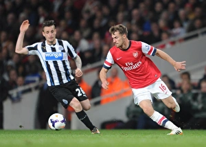 Arsenal v Newcastle United 2013/14 Gallery: Aaron Ramsey (Arsenal) Mathieu Debuchy (Newcastle). Arsenal 2: 0 Newcastle United