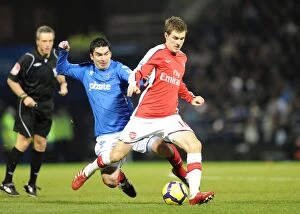 Portsmouth v Arsenal 2009-10 Collection: Aaron Ramsey (Arsenal) Richard Hughes (Portsmouth). Portsmouth 1: 4 Arsenal