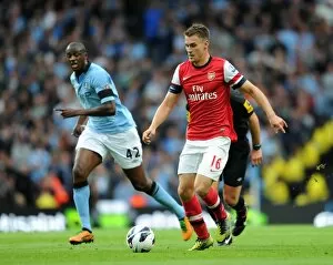 Manchester City v Arsenal 2012:13 Gallery: Aaron Ramsey (Arsenal) Yaya Toure (Man City). Manchester City 1: 1 Arsenal