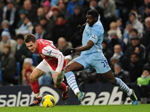 Images Dated 18th December 2011: Aaron Ramsey Dashes Past Kolo Toure: Manchester City vs. Arsenal, Premier League, 2011-12