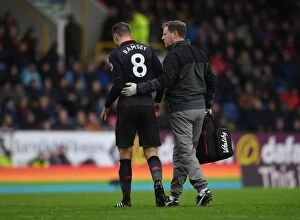 Images Dated 26th November 2017: Aaron Ramsey Injured: Arsenal's Midfielder Carried Off the Pitch by Physio Colin Lewin During