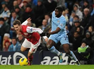 Images Dated 18th December 2011: Aaron Ramsey Outmaneuvers Kolo Toure: A Pivotal Moment in the Manchester City vs