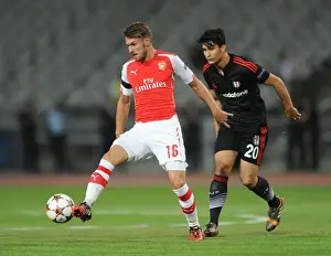 Besiktas V Arsenal 2014-15 Prints: Aaron Ramsey Outmaneuvers Necip Uysal in Arsenal's UEFA Champions League Clash against Besiktas